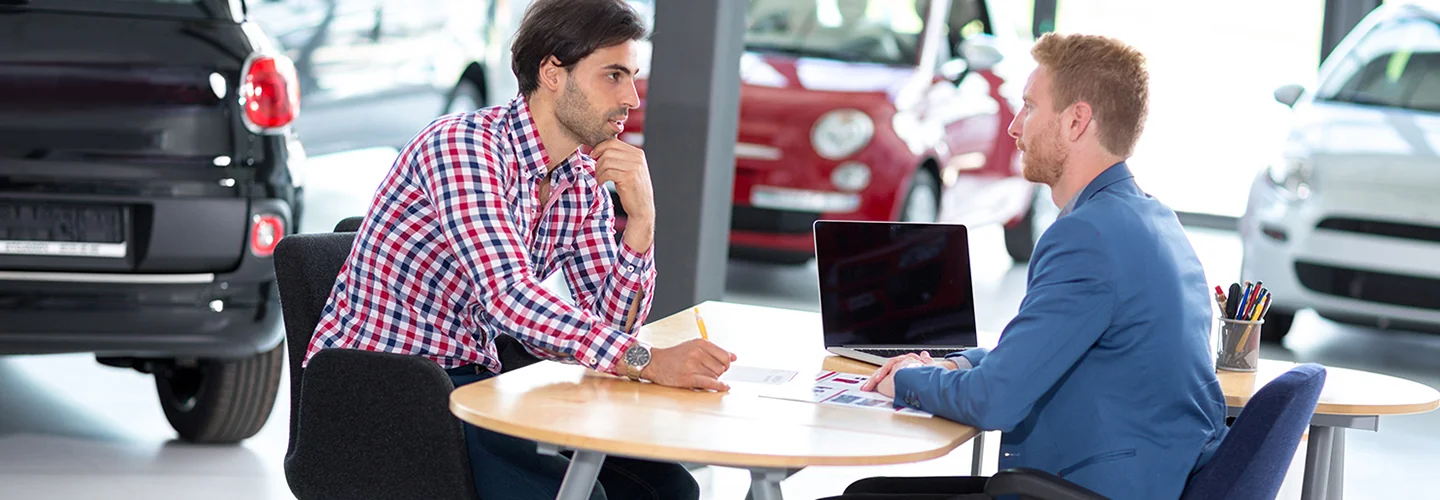 a person talking with salesperson in dealerhisp
