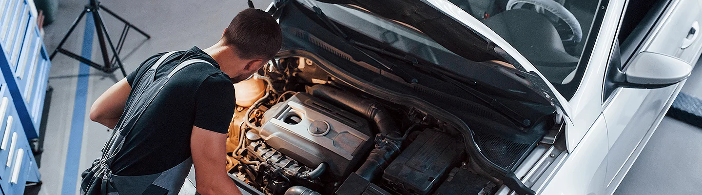 top view of auto mechanic working on car engine