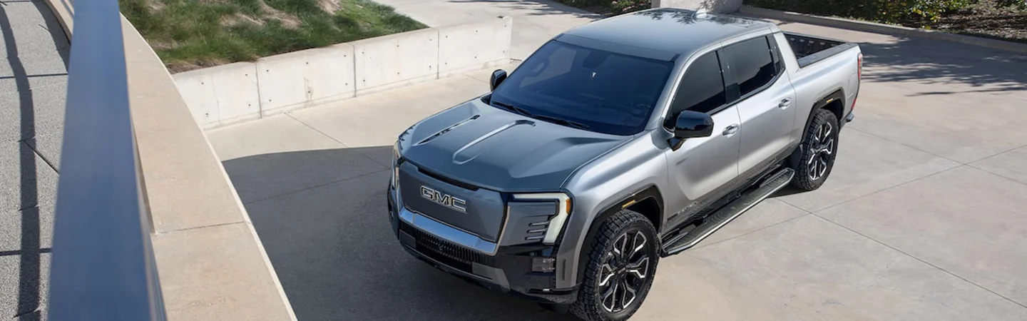 Gray 2024 GMC Sierra EV Denali Edition 1 parked in a driveway