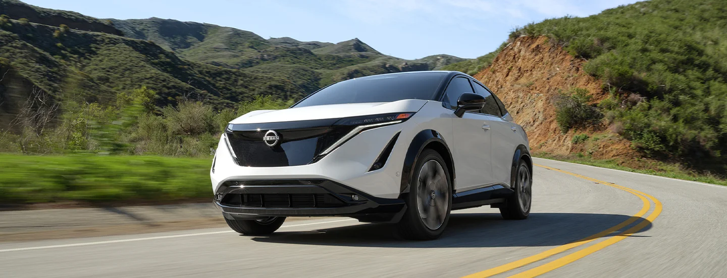 front view of a white 2025 Nissan ARIYA on a curve