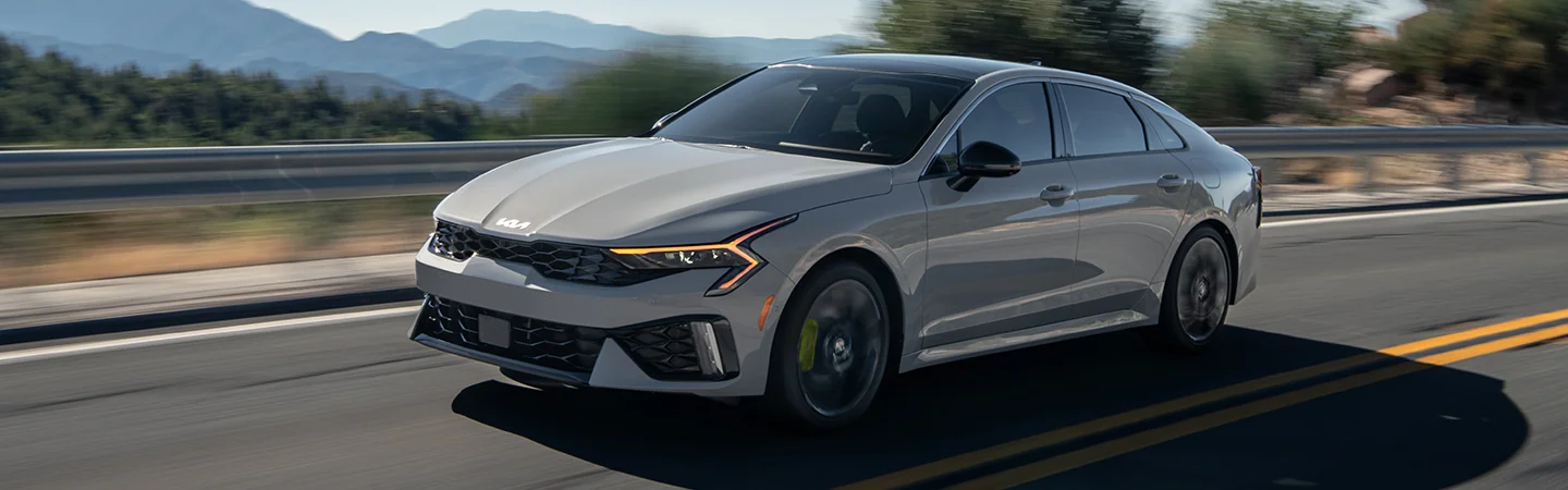 gray 2025 Kia K5 driving on highway