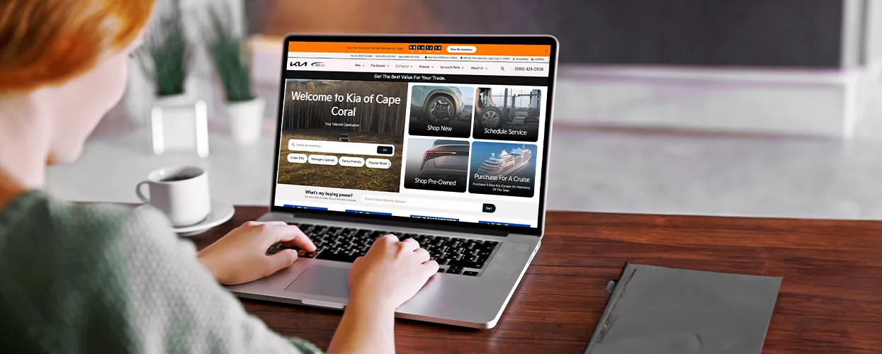 Woman using the kia of cape coral website on her laptop