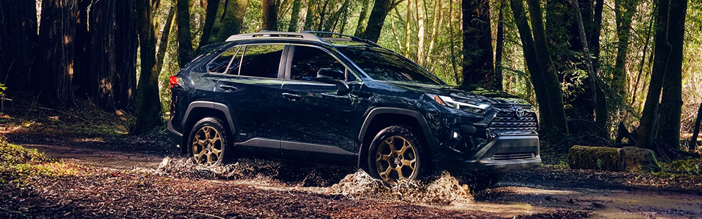 2025 Toyota RAV4 LE offroad in a creek crossing