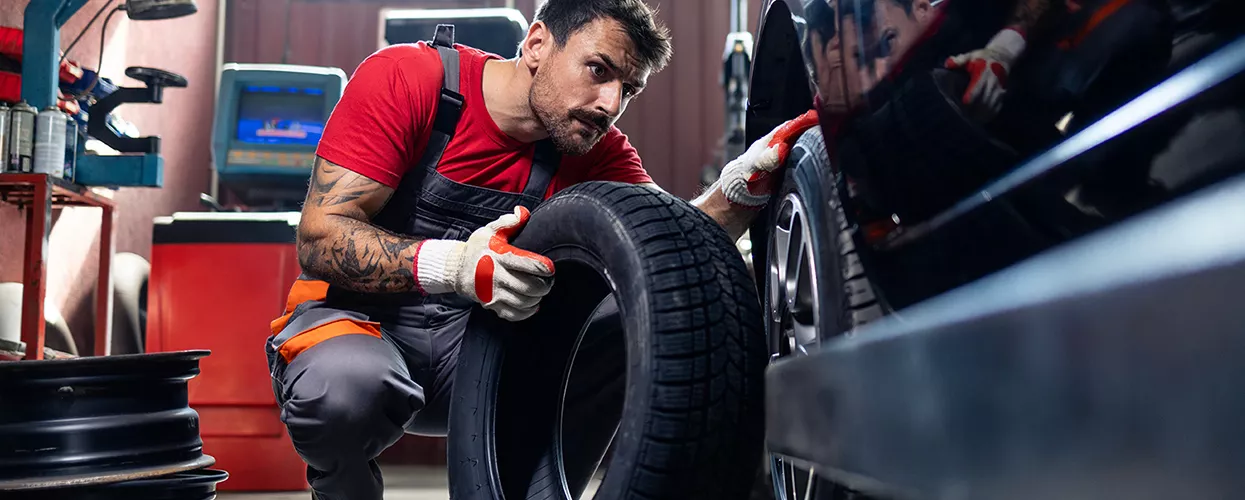 Service mechanic changing the tires on a vehicle