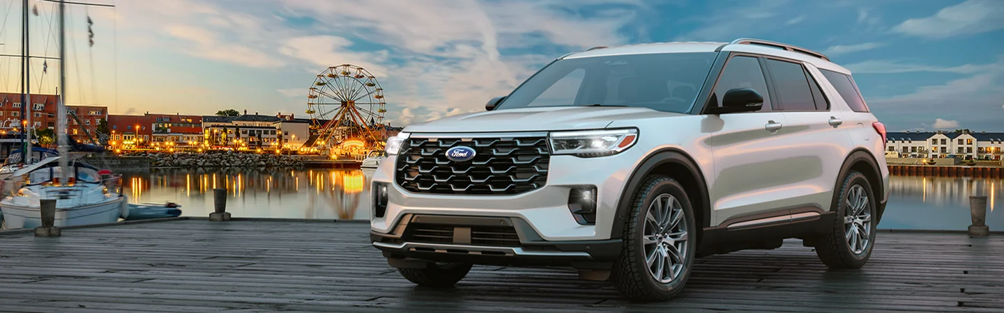 A front view of a white 2025 Ford Explorer parked on a dock