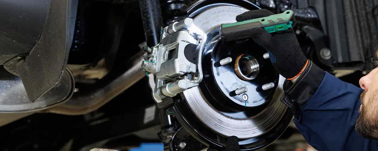 Service mechanic working on the brakes of a vehicle