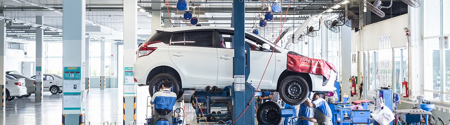 white Toyota being worked on in garage