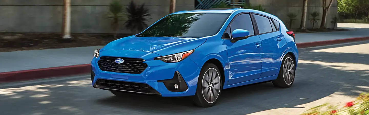 2024 Subaru Impreza vs Honda Civic blue front view