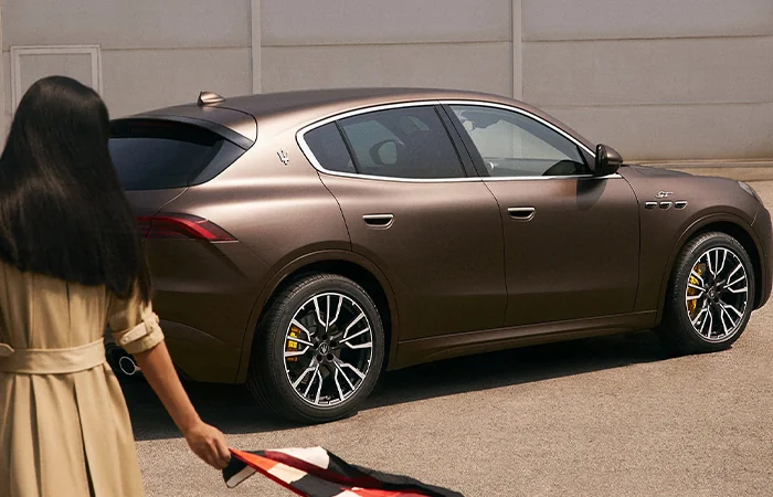 Side view of a brown Maserati Grecale parked