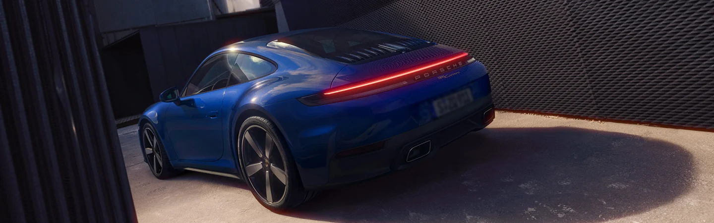 a rear view of a glue 2026 Porsche 911 Carrera