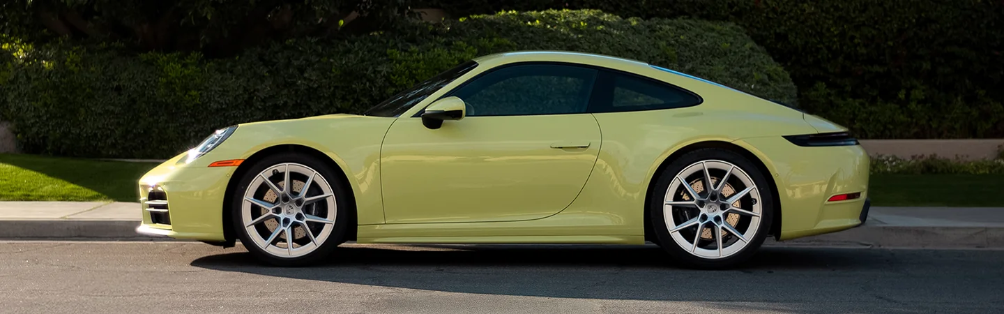 driver side view of a yellow 2026 Porsche 911 Carrera