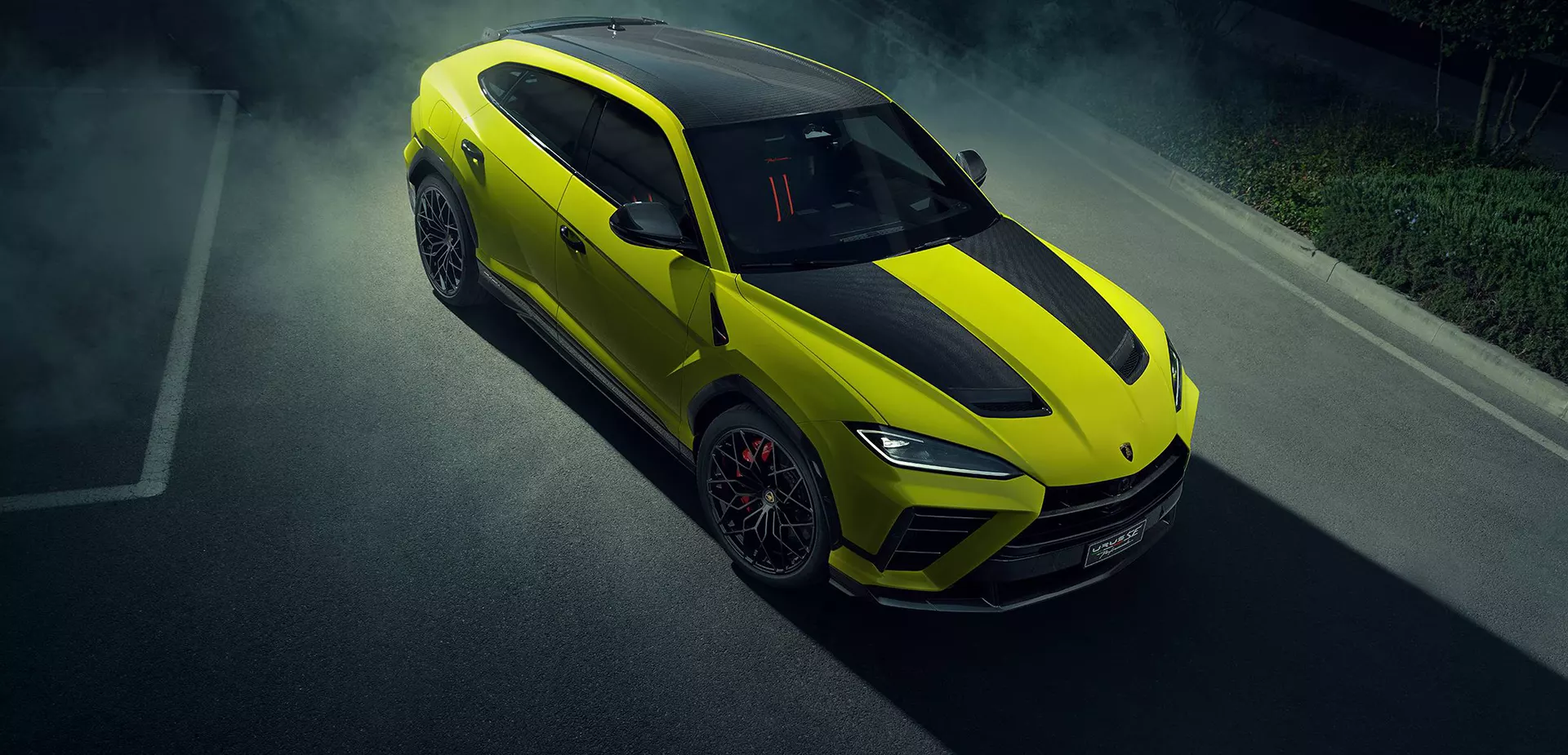 A green 2026 Lamborghini Urus SE driving on a road