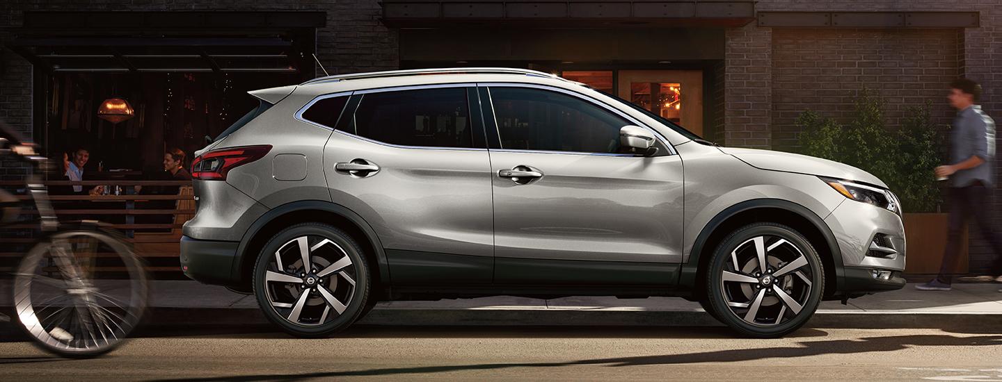 Gray 2021 Nissan Rogue parked in front of a store