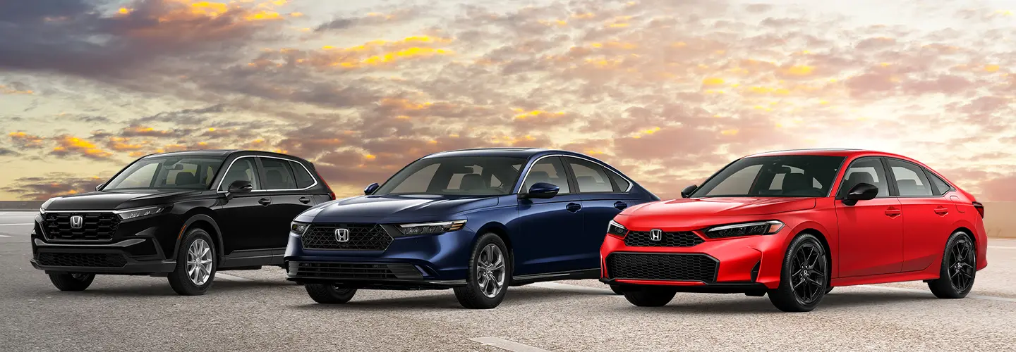 lineup of brand new Honda vehicles under dramatic sunset