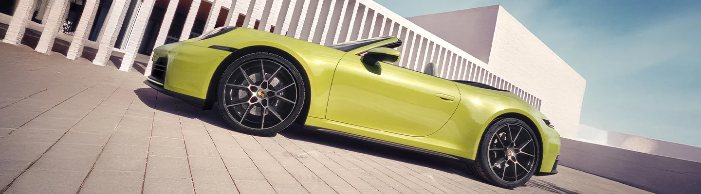 a yellow convertible Porsche 911 with it's top down