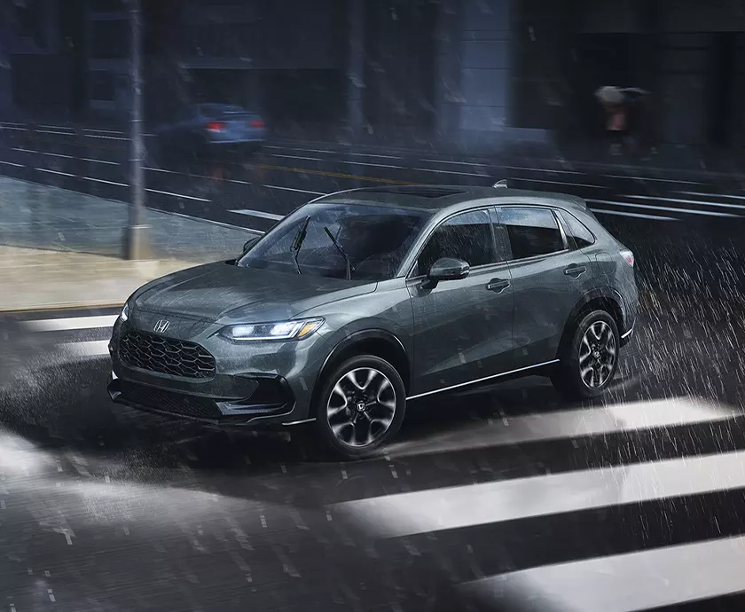 dark gray Honda HR-V exterior drivning in city