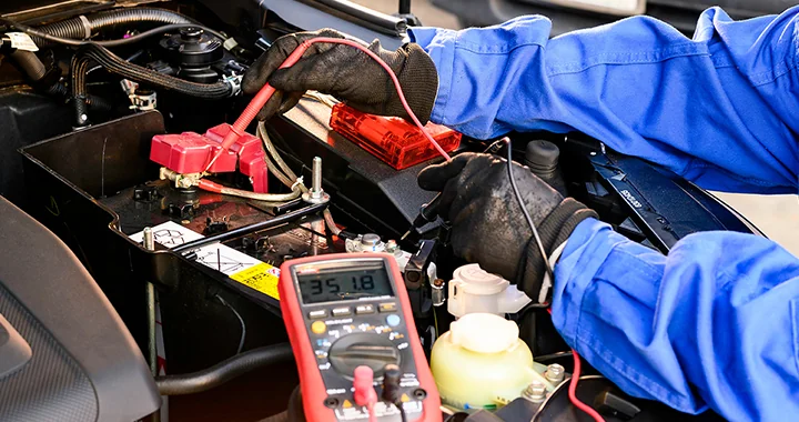BMW service tech testing a battery