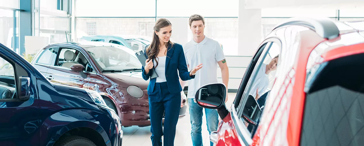 MINI of Coconut Creek South Florida car salesman showing a customer around the dealesrhip