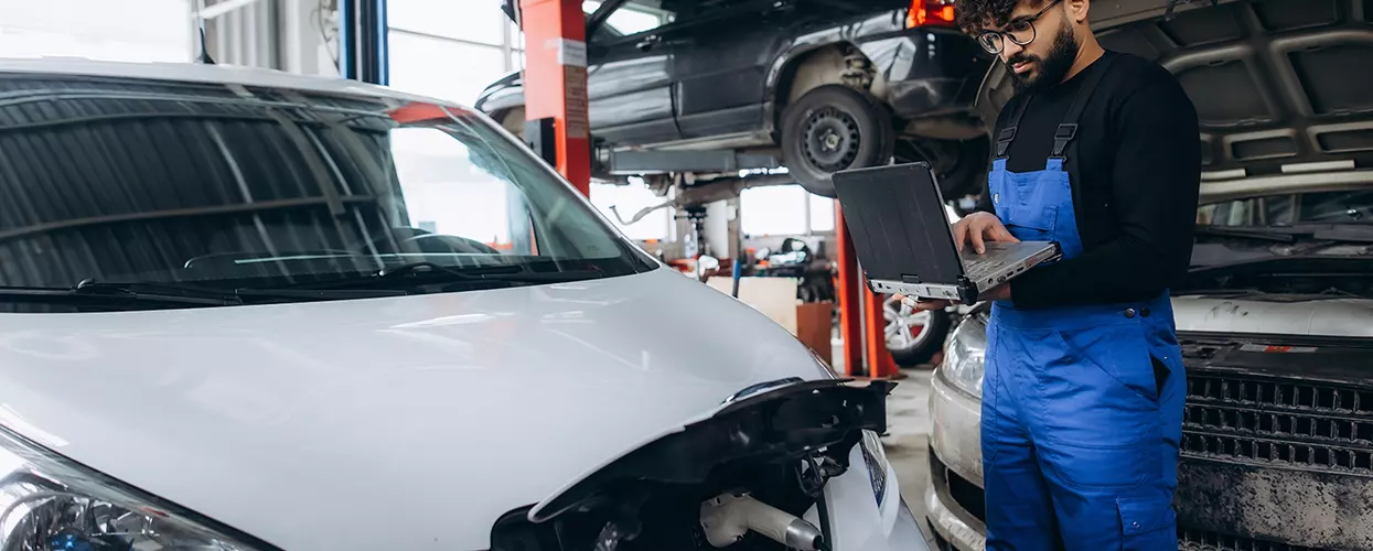 Kia service tech doing recommended maintenance
