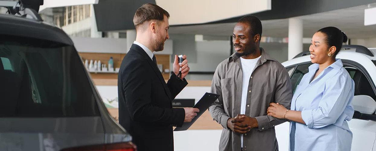 Sales person handing over car keys after buying a Lamborghini