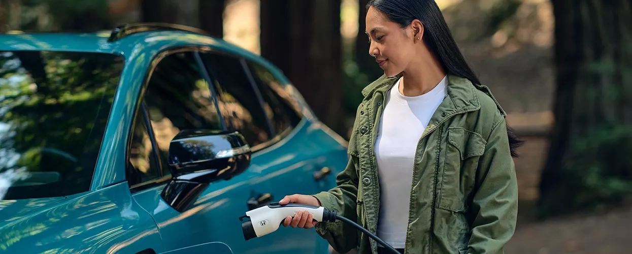 Woman charging her Electric Vehicle