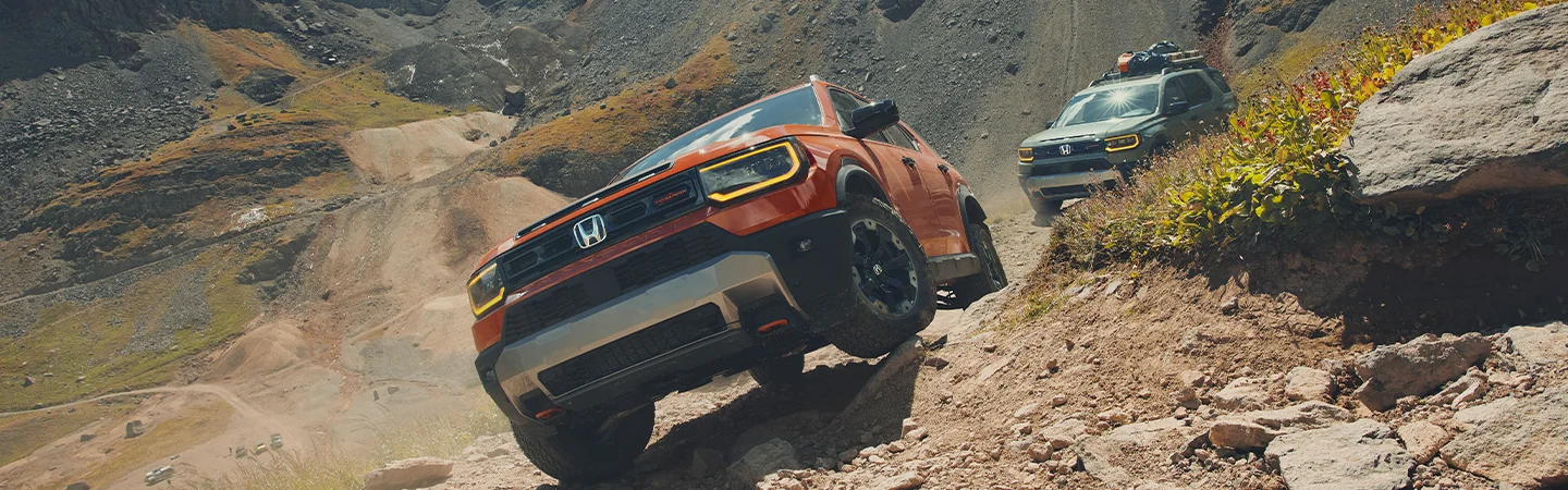 2026 Honda Passport RTL popping a one wheely offroad with another Passport