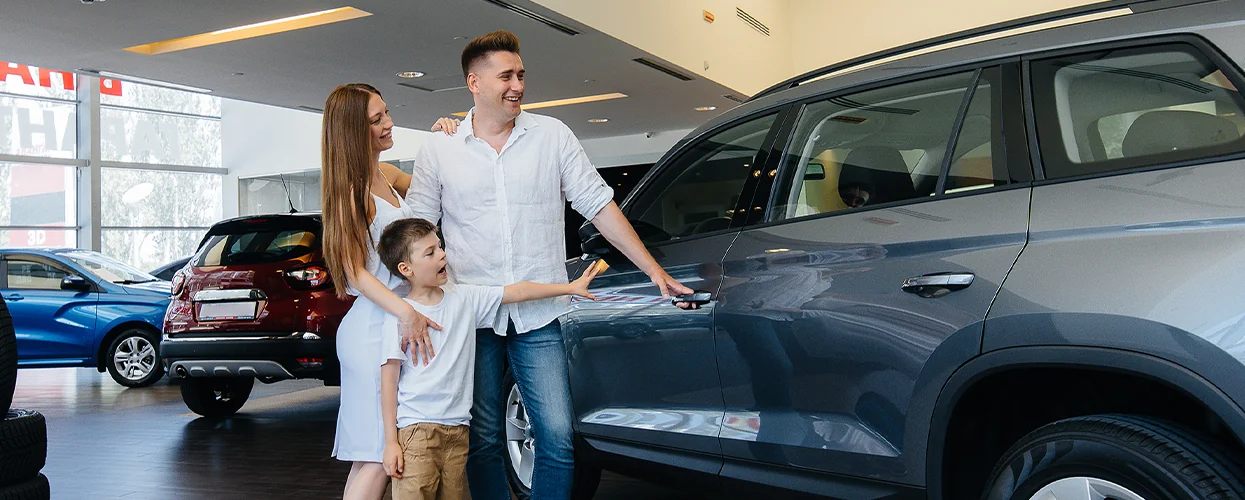 A family in a show room looking at new Nissan SUVs