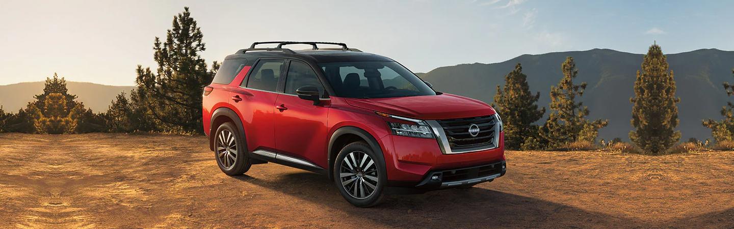 Black and red 2022 Nissan Pathfinder parked on a dirt road