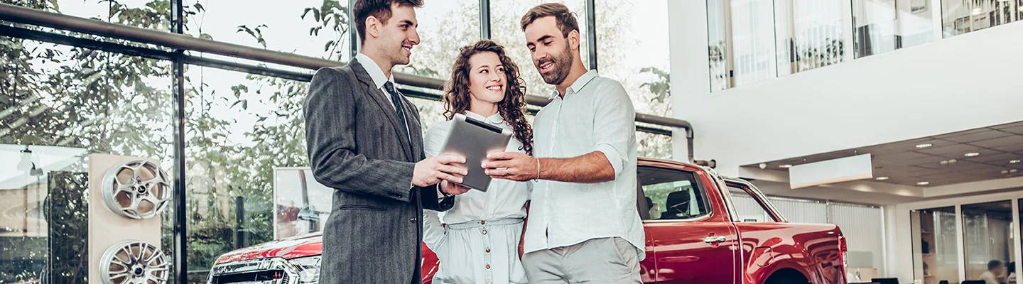 salesman reviewing contract with couple