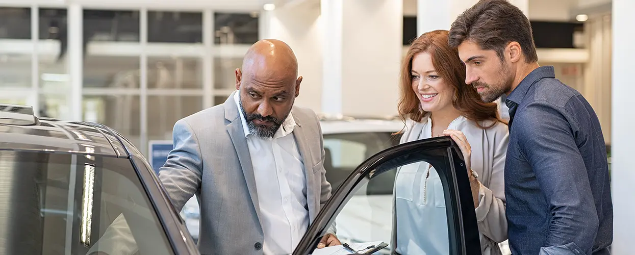 man and woman excited to buy new car from Toyota of Tampa Bay