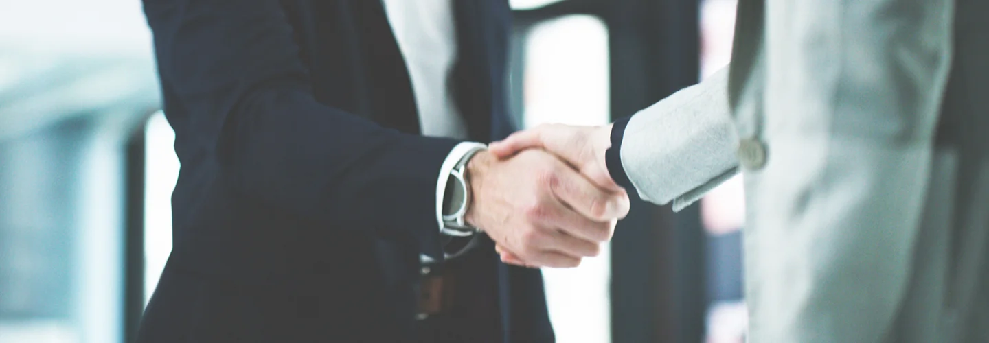 Sales person and customer shaking hands