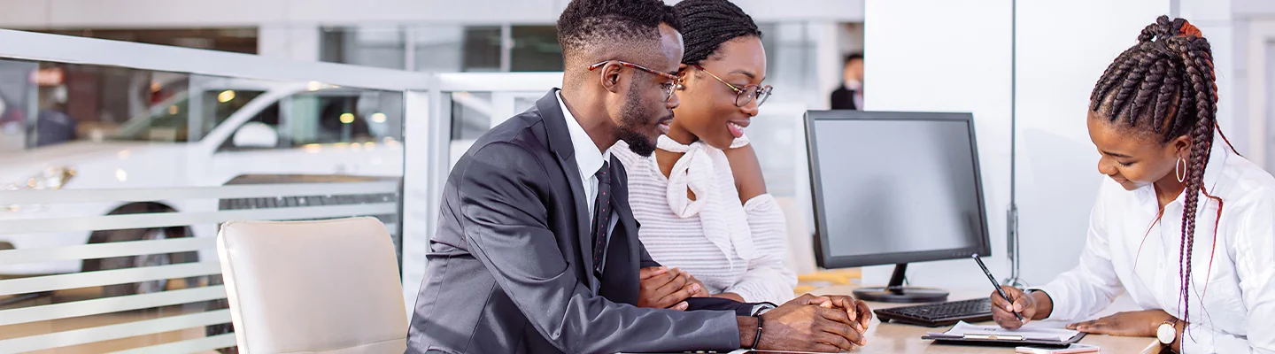 husband and wife going over a contract with the sales woman