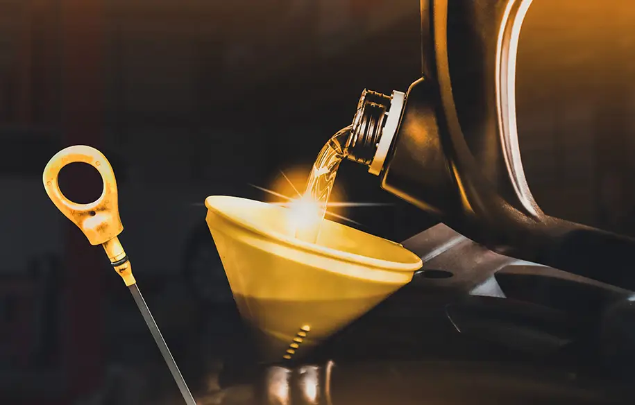 Pouring fresh oil into crankcase