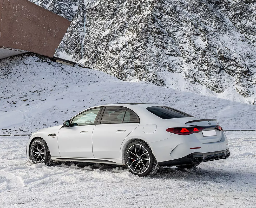 new white Mercedes-Benz parked in snow