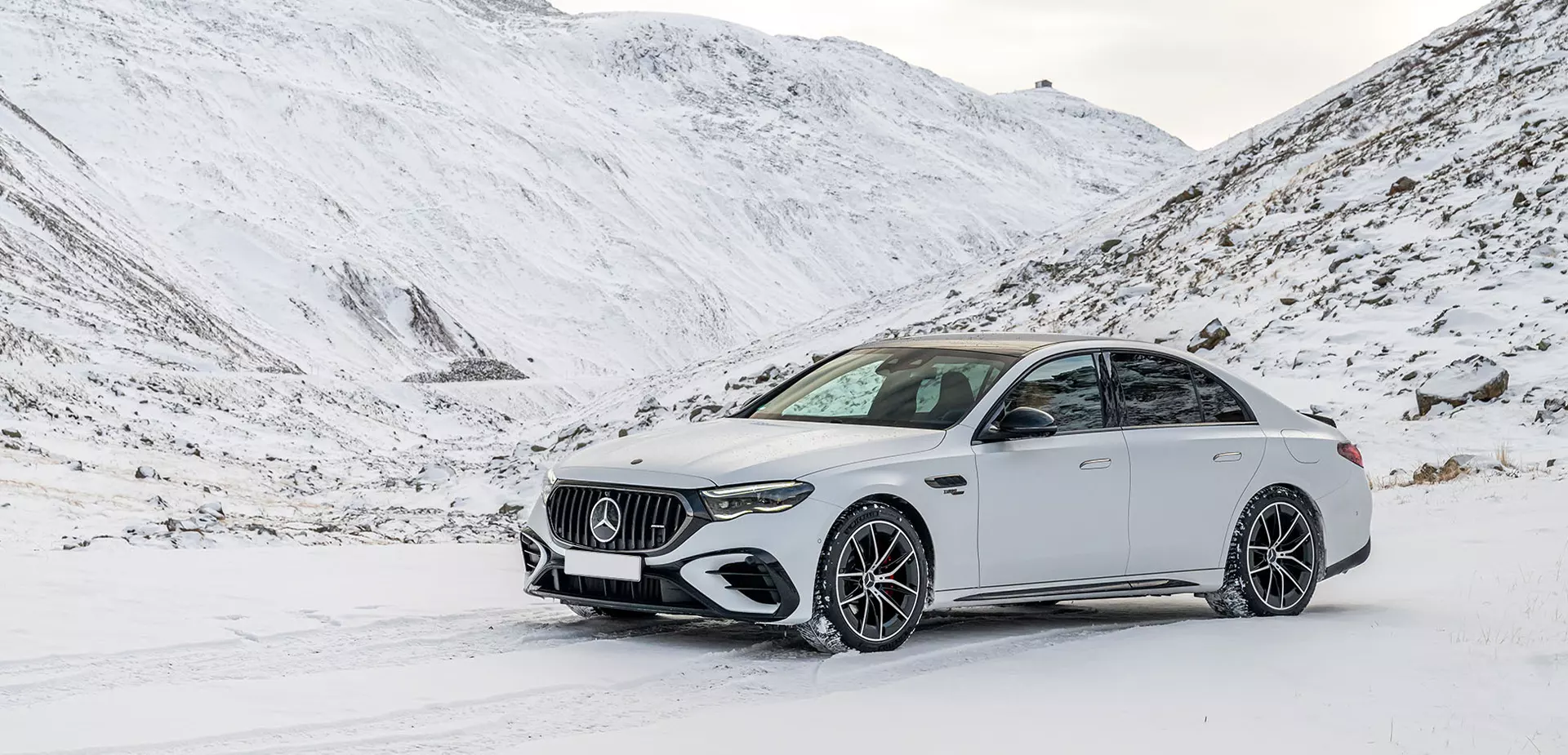 new white Mercedes-Benz parked in snow