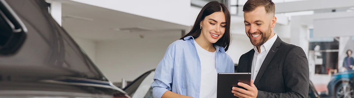 discussing new car prices in car showroom