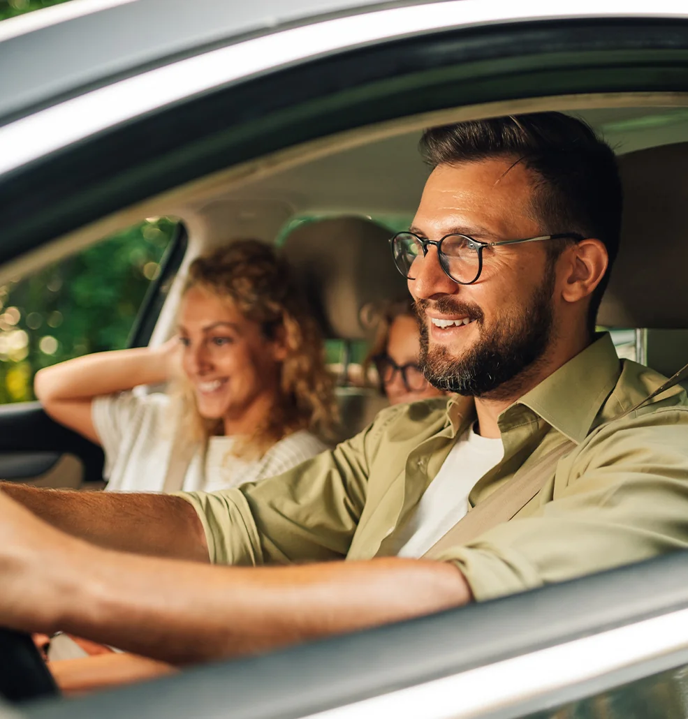 three people smiling on a test drive at Chrysler Dodge Jeep Ram dealership in Tampa, FL