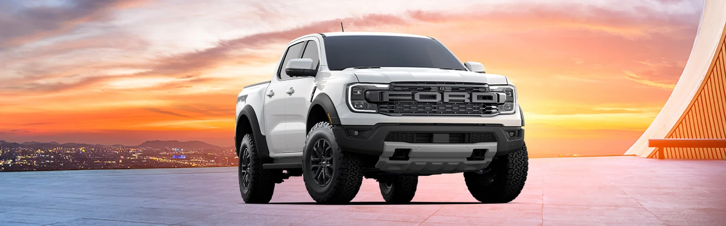 White 2025 Ford Ranger Raptor parked with the city in the background