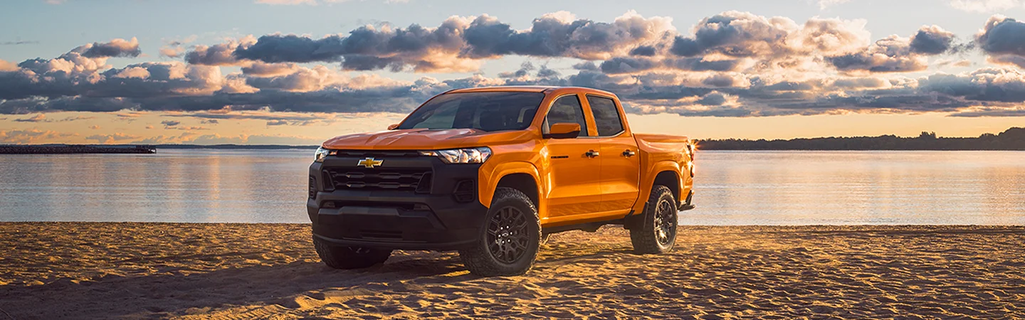 Orange 2025 Chevrolet Colorado parked at the beach