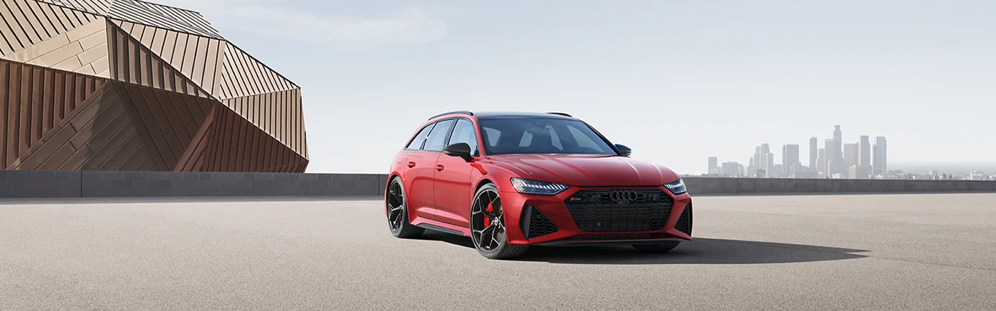2025 Audi RS6 Avant Performance parked with skyline behind in distant view