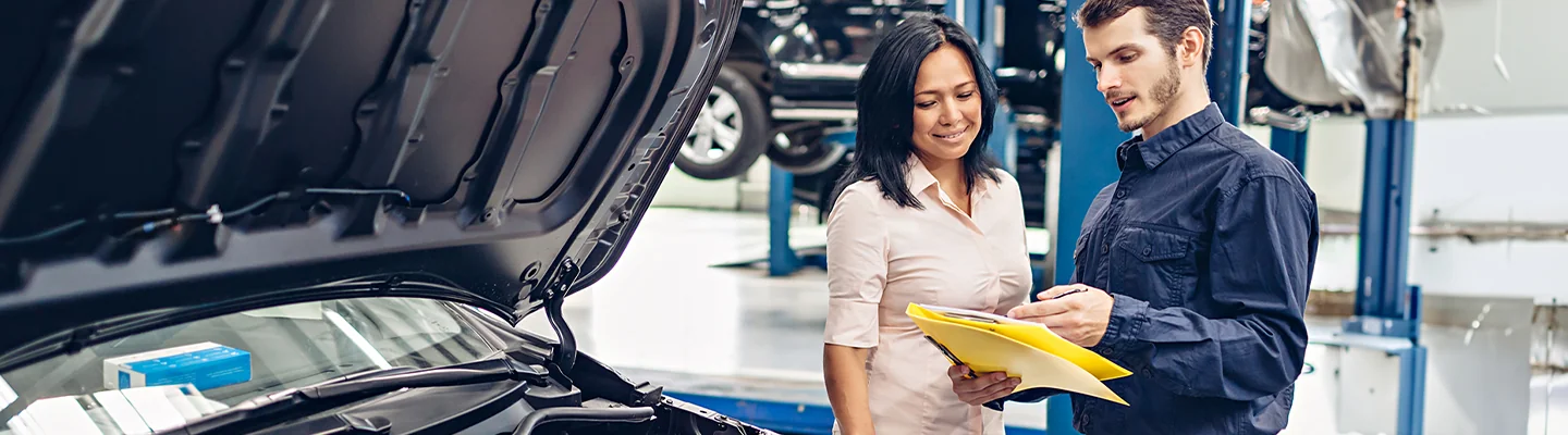 Service technician showing someone information about service for a Subaru Outback