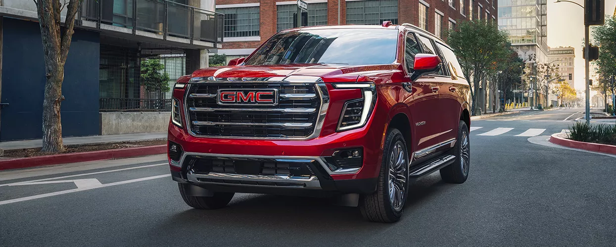 GMC Yukon driving through a town