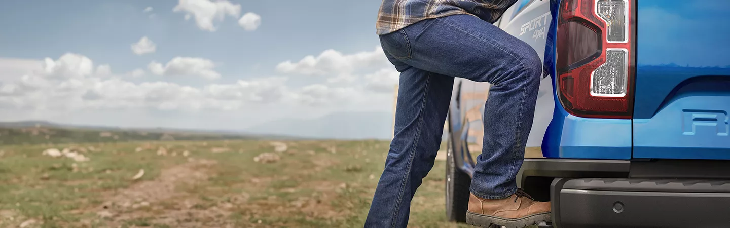 Person stepping up into a 2025 Ford Ranger Raptor®