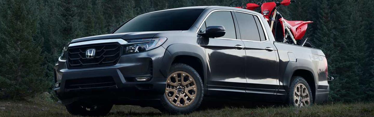 2021 Passport front driver side view with 2 dirt bikes in back