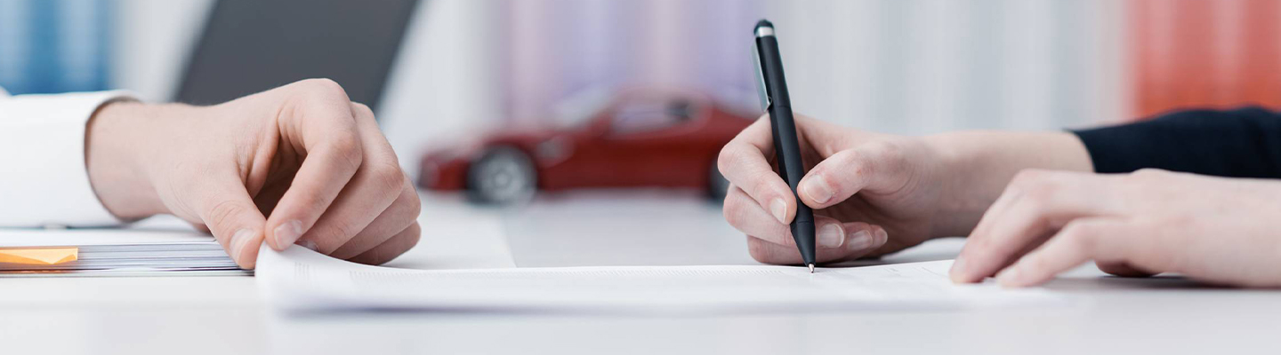 Signing lease documents for a brand new car