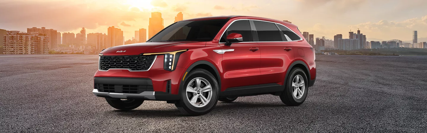 A blue 2025 Kia Sorento drivng in some snow