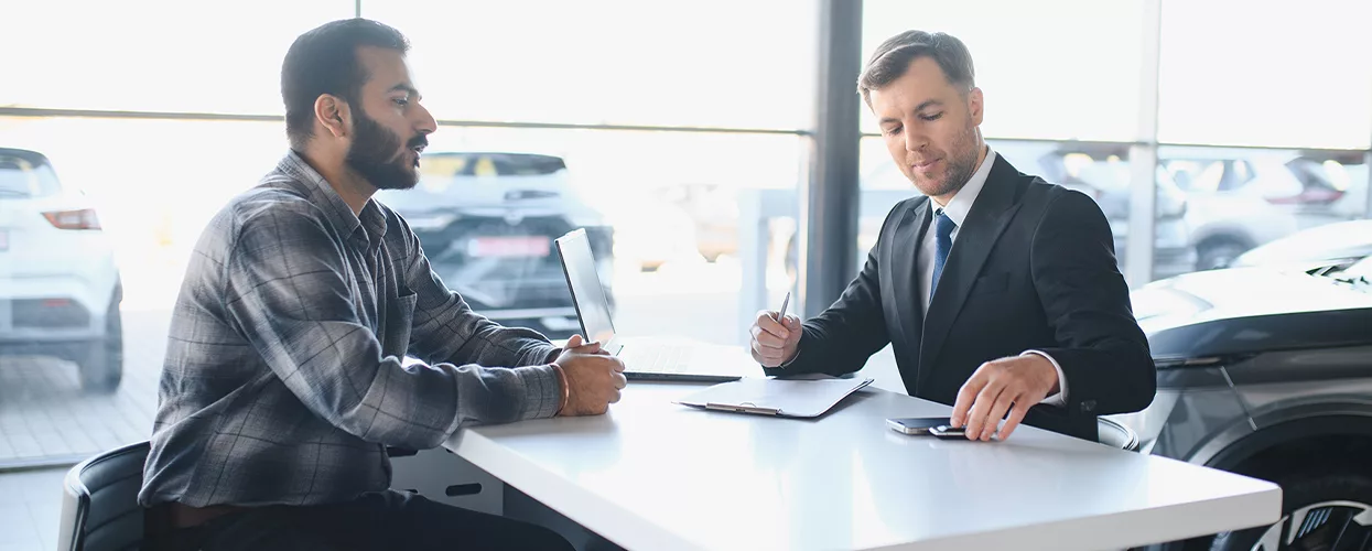 Car salesman talking to a customer about a contract