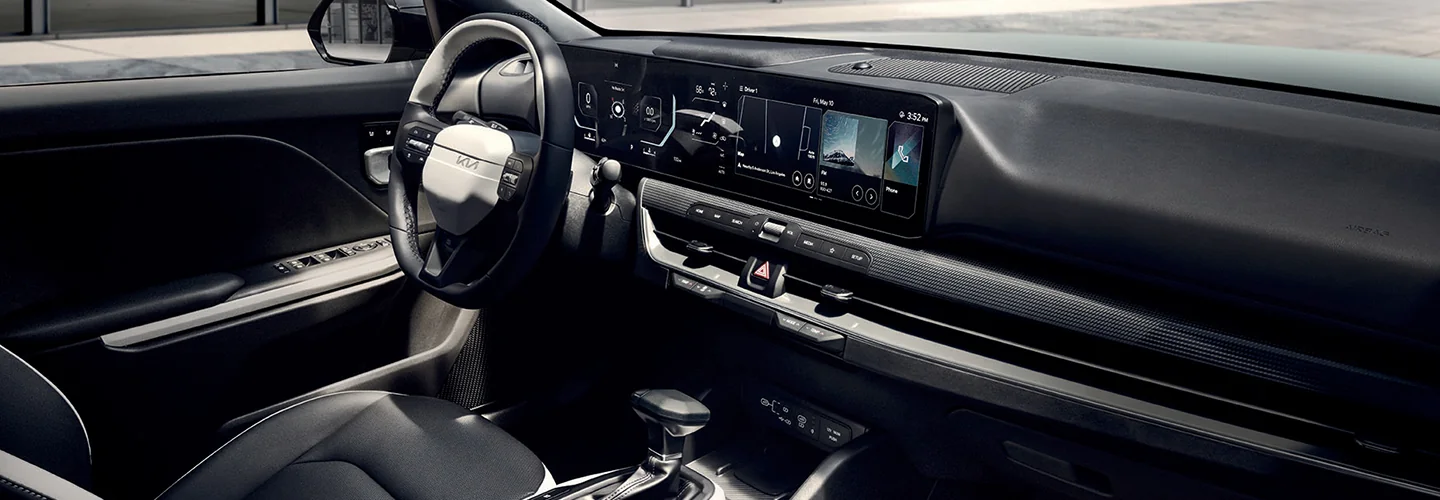 Interior view of the dashboard and tech in a 2025 Kia K4