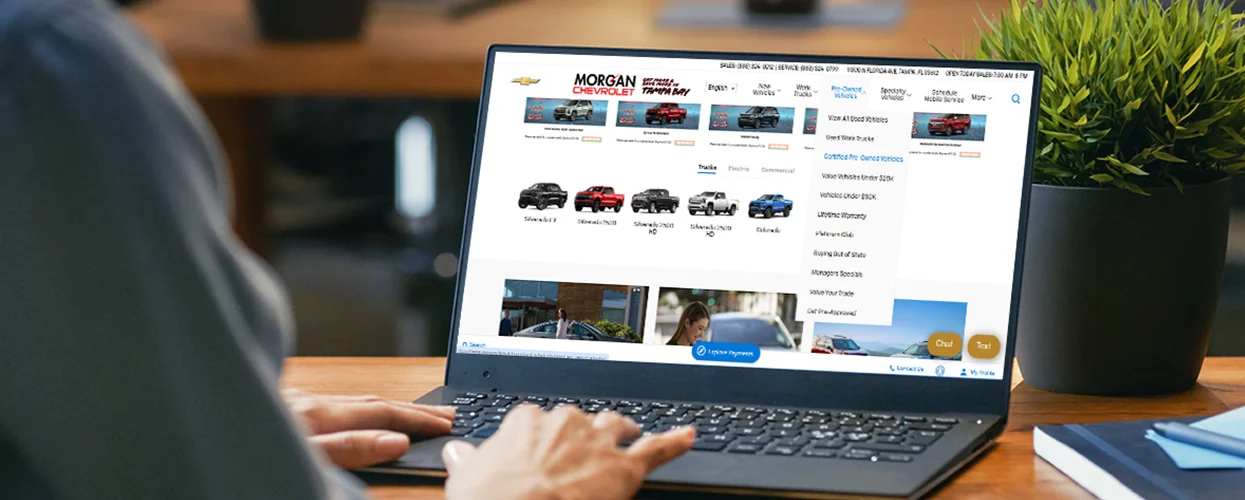 Person at home shopping online to buy a new pre-owned car