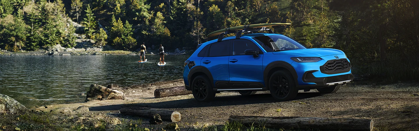 a blue 2026 Honda HR-V LX with paddleboard on top